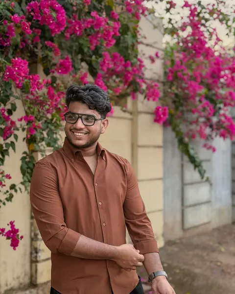 Ishaque under a bougainvillea